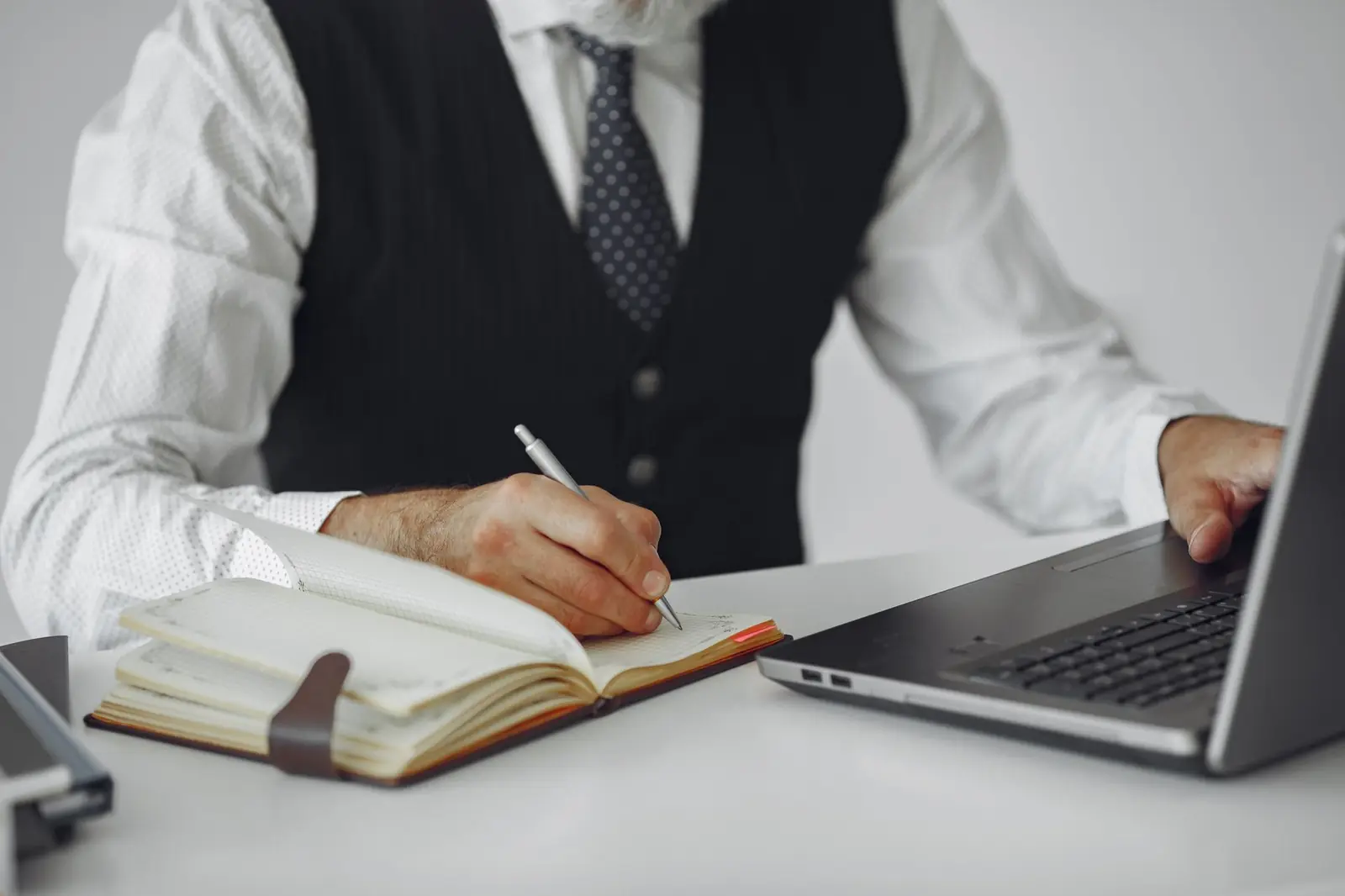 Planning notes next to a laptop on a desk