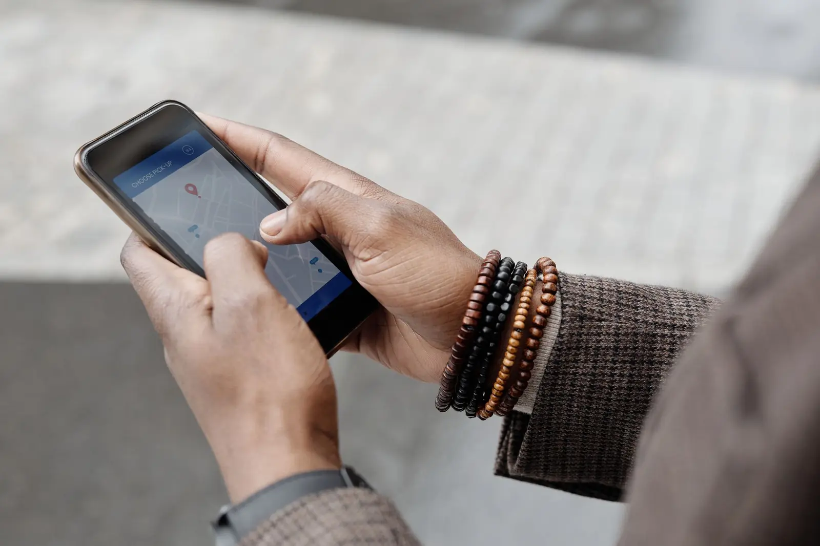 Hands searching a map app on a phone