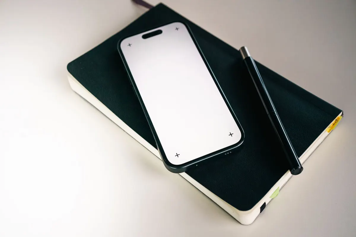 A phone lying silent on a closed notebook