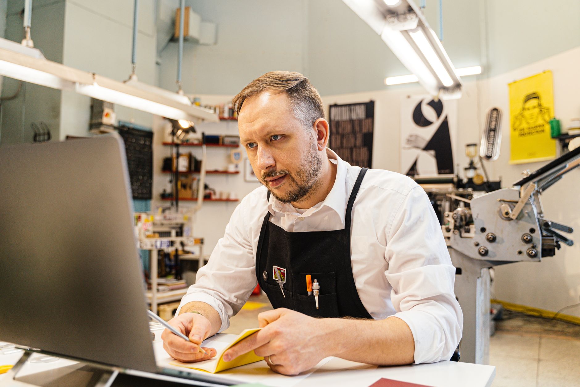 Local business owner reviewing his website on a laptop in his workshop