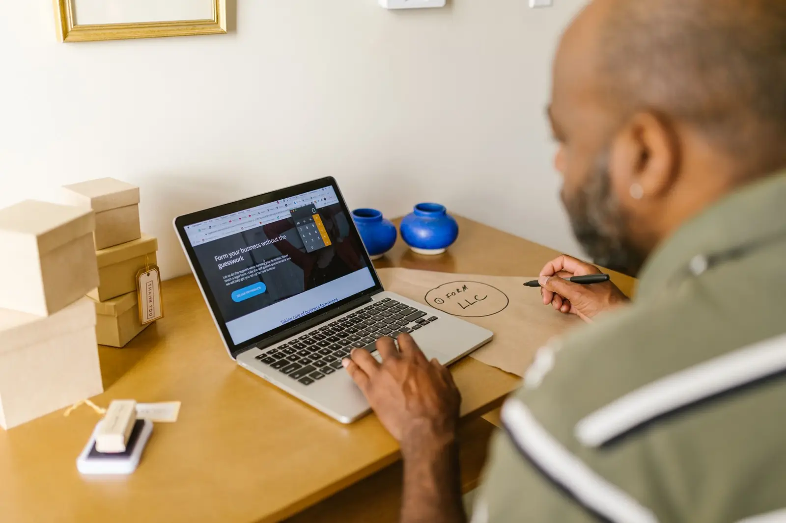 Business owner answering inquiries on a laptop
