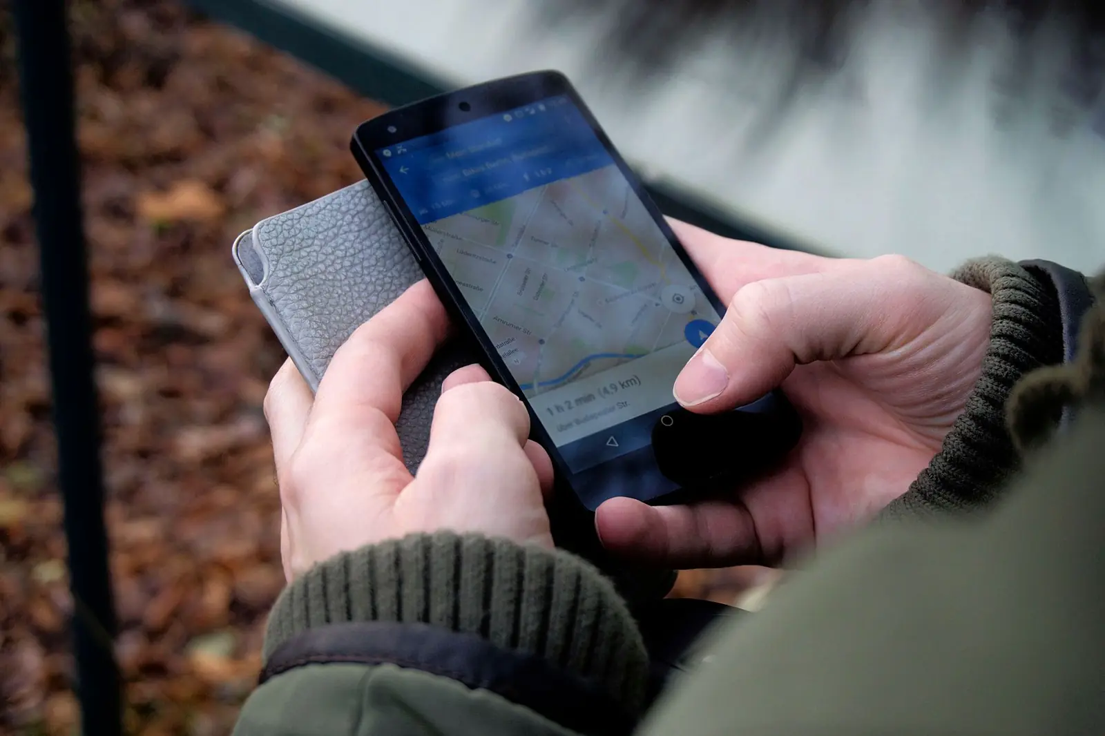 Person searching a map on a smartphone