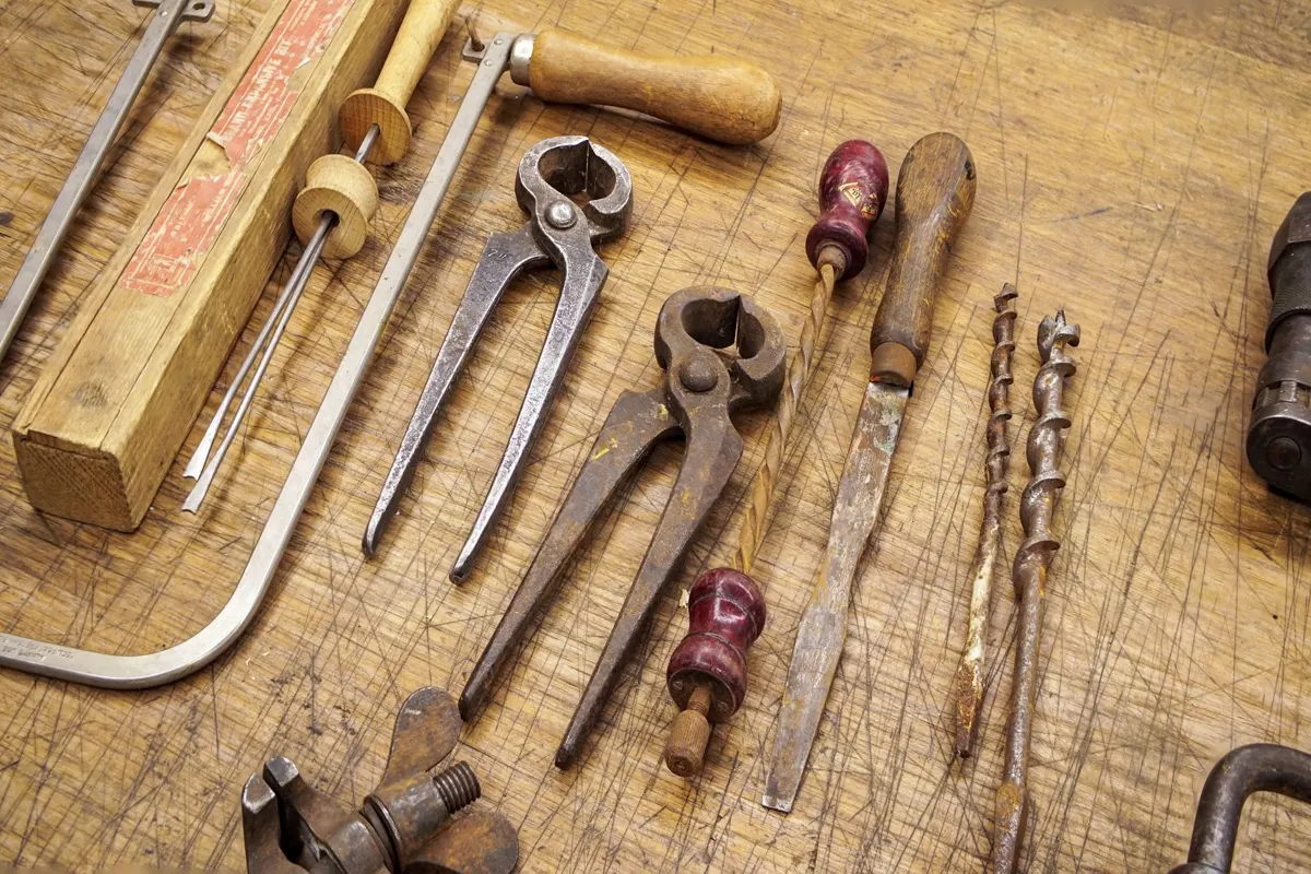 Hand tools laid out on a wooden workbench